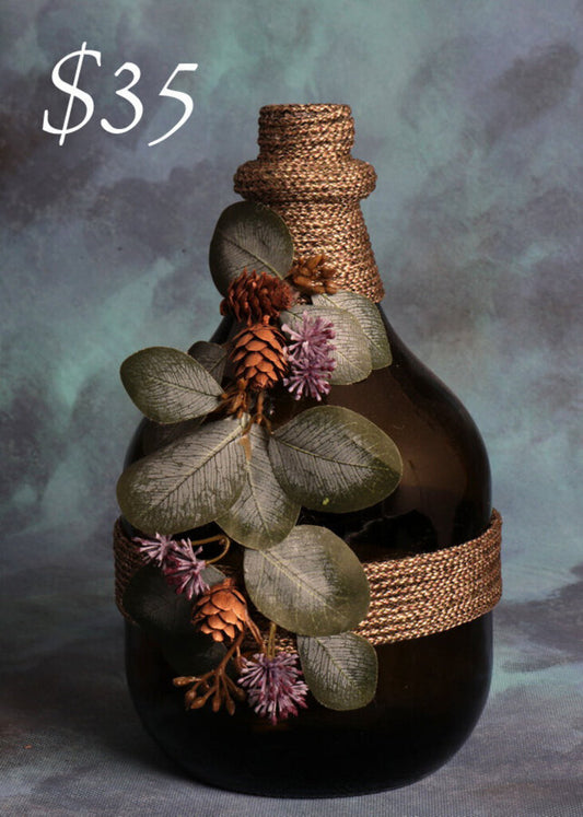 Wine bottle with tan jute and vine with purple flowers