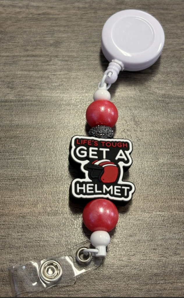 Helmet badge reel